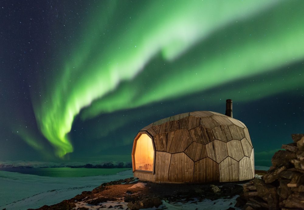 These rock-like Norwegian cabins keep hikers warm under timber panels