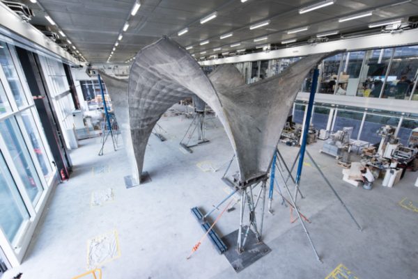 Ultrathin concrete roof to cap a net-positive energy rooftop apartment